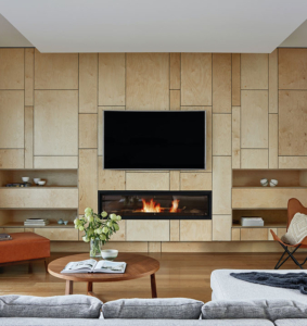 A living room with a fireplace and television.