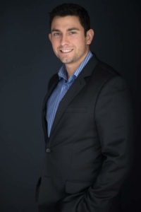 A man in a suit and blue shirt