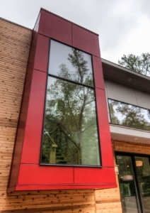 A building with a large window and red trim.