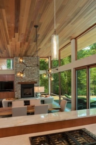 A living room with a fireplace and a large window.