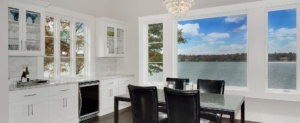 A dining room with a view of the water