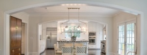 A kitchen with white walls and a large table