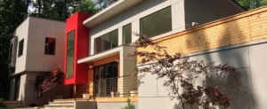 A building with many windows and a tree in front of it.