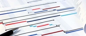 A close up of several different colored lines on paper
