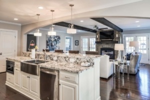 A kitchen with white cabinets and black accents