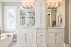 A bathroom with two sinks and a large mirror.