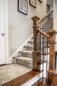 A staircase with wood and metal railing.