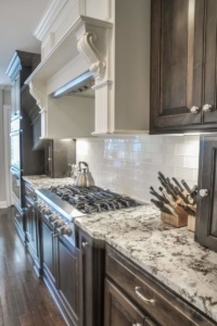A kitchen with granite countertops and wooden cabinets.