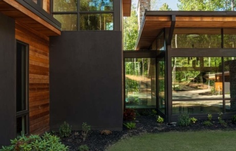 A house with a lawn and trees in the background