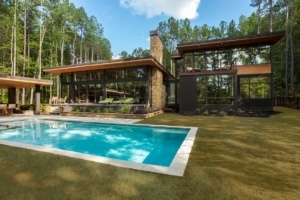 A large pool in front of a house.
