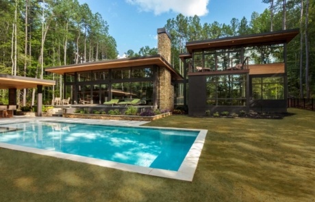 A large pool in front of a house.