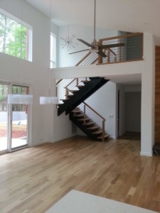 A large open floor plan with stairs leading to the second story.