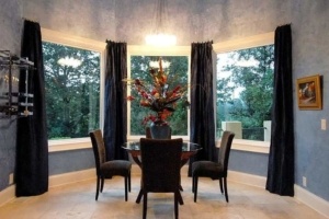 A dining room with four chairs and a table