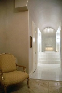 A chair in the middle of a room with white tile floors.