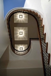 A staircase with three lights on each side of it.