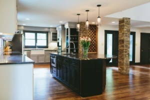 A kitchen with a large island and wooden floors