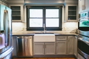 A kitchen with a sink and dishwasher in it