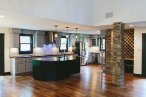 A kitchen with an island and wooden floors