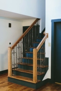 A staircase with wood and metal railing.