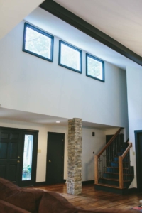 A large open floor plan with three windows.