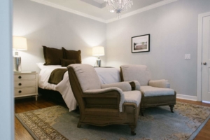 A bed room with a couch and chair