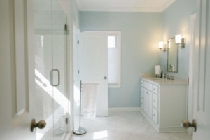 A bathroom with white tile floors and walls.