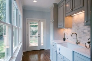 A kitchen with a sink and a door
