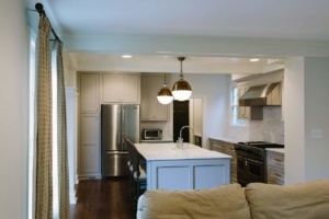 A kitchen with a large island and stainless steel appliances.