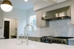 A kitchen with white counters and stainless steel appliances.