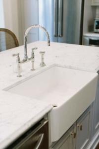 A white sink sitting under a kitchen counter.