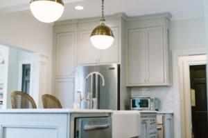 A kitchen with white cabinets and stainless steel appliances.