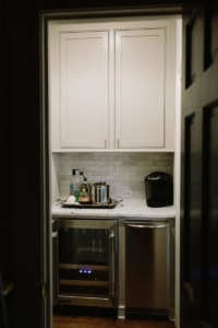 A kitchen with white cabinets and stainless steel appliances.
