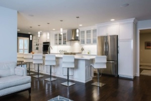A kitchen with white cabinets and stainless steel appliances.