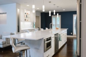 A kitchen with white cabinets and stainless steel appliances.