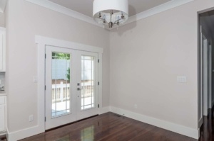 A room with two doors and a wooden floor
