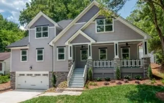 A house with a garage and steps leading to the front door.