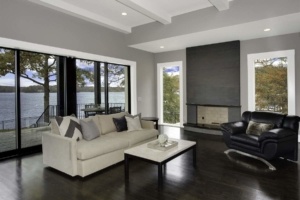 A living room with a couch, chair and fireplace.