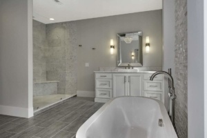 A bathroom with a tub, sink and shower.