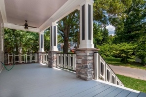 A porch with columns and pillars in the middle of it.