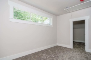 A room with a window and carpet in it