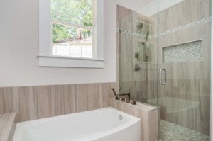 A bathroom with a tub and shower in it