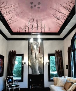 A living room with a large mirror and two windows.