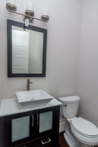 A bathroom with a sink, mirror and toilet.