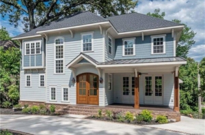 A large blue house with a lot of windows.