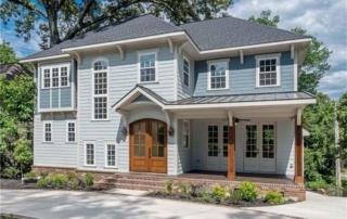 A large blue house with a lot of windows.