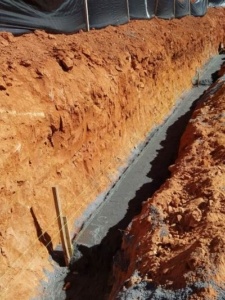 A close up of the side of a wall with a trench