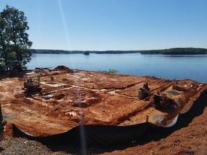 A large piece of wood sitting on top of a beach.