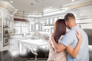 A couple is hugging in the kitchen with an unfinished drawing of it.