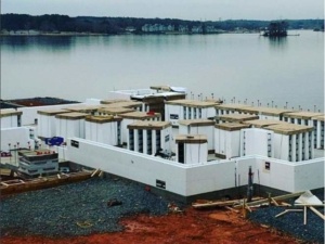 A building under construction near the water.