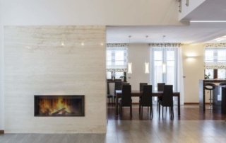 A room with a fireplace and dining table.